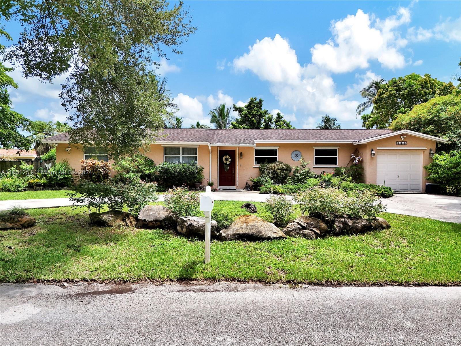 a front view of house with yard and green space