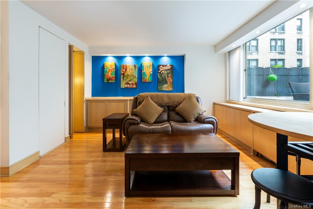 a living room with furniture and a floor to ceiling window