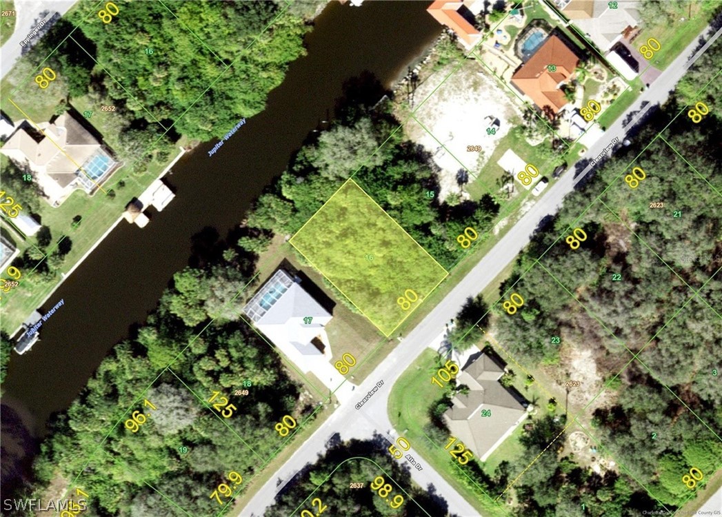 an aerial view of a residential houses with yard