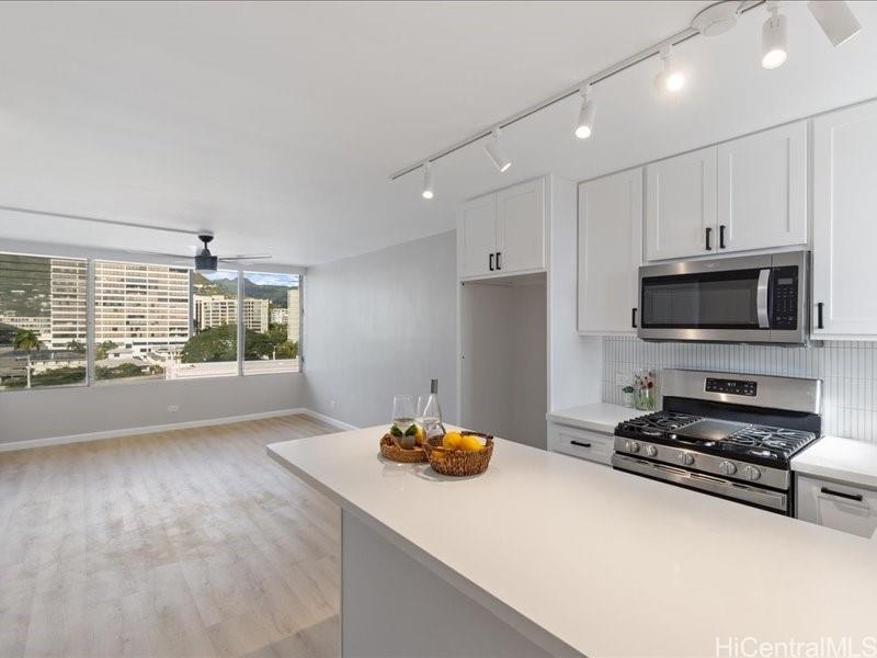 a kitchen with stainless steel appliances a stove a sink and a refrigerator