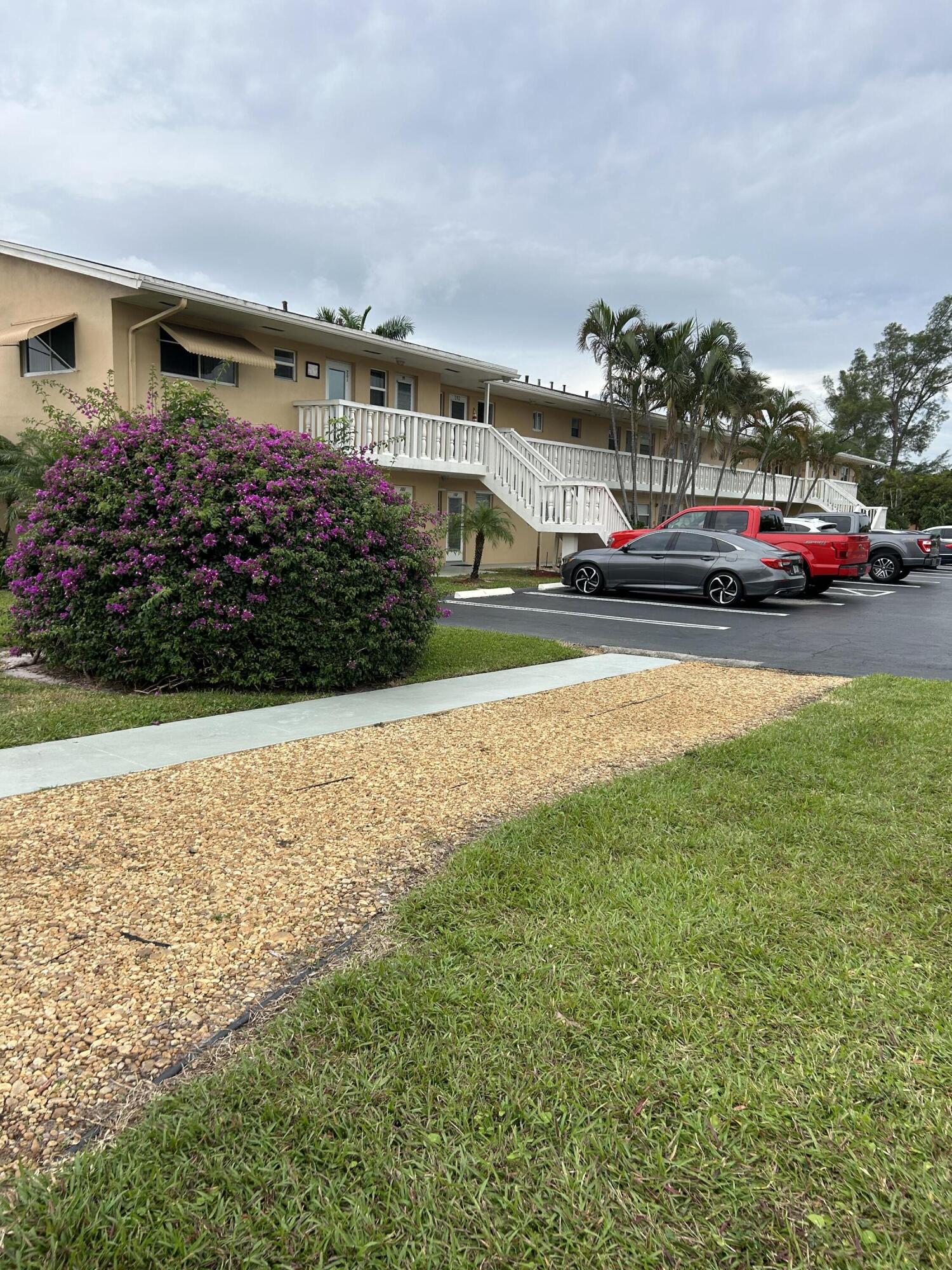 a front view of house with yard and car parked