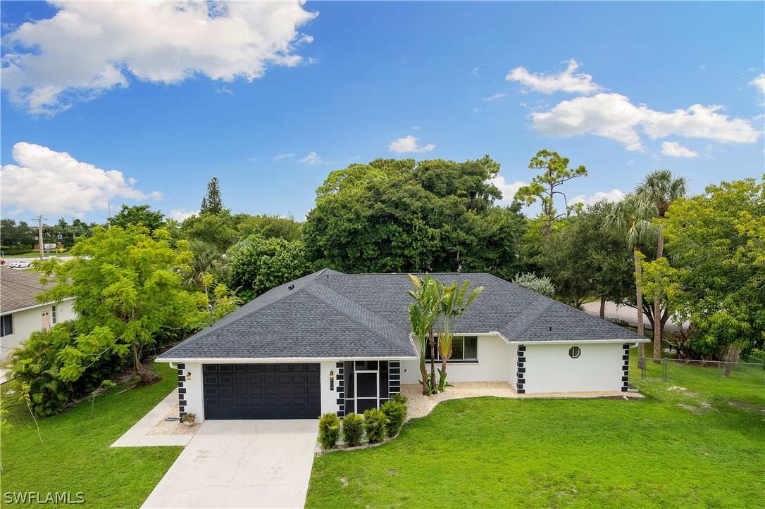 a aerial view of a house with garden and a yard