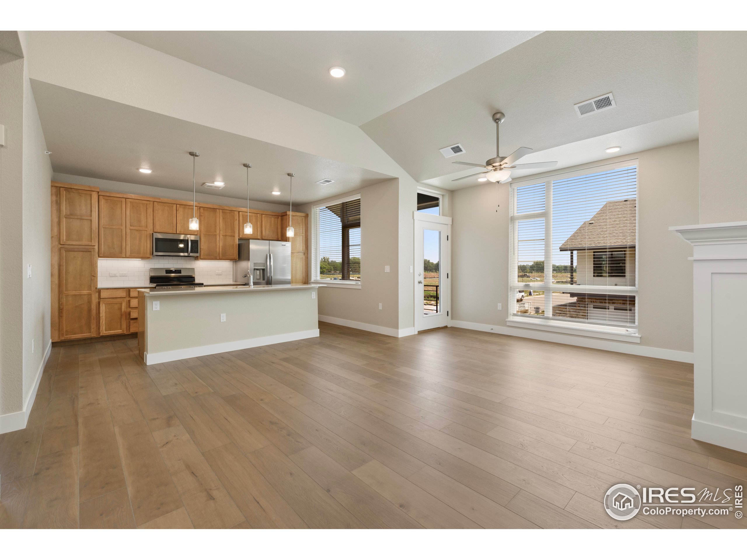 a view of a kitchen with a sink stove and cabinets