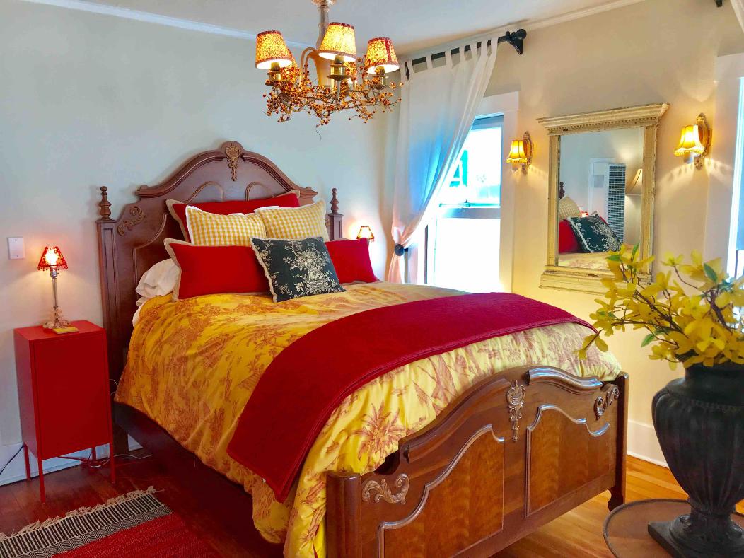 a bedroom with a bed and a chandelier