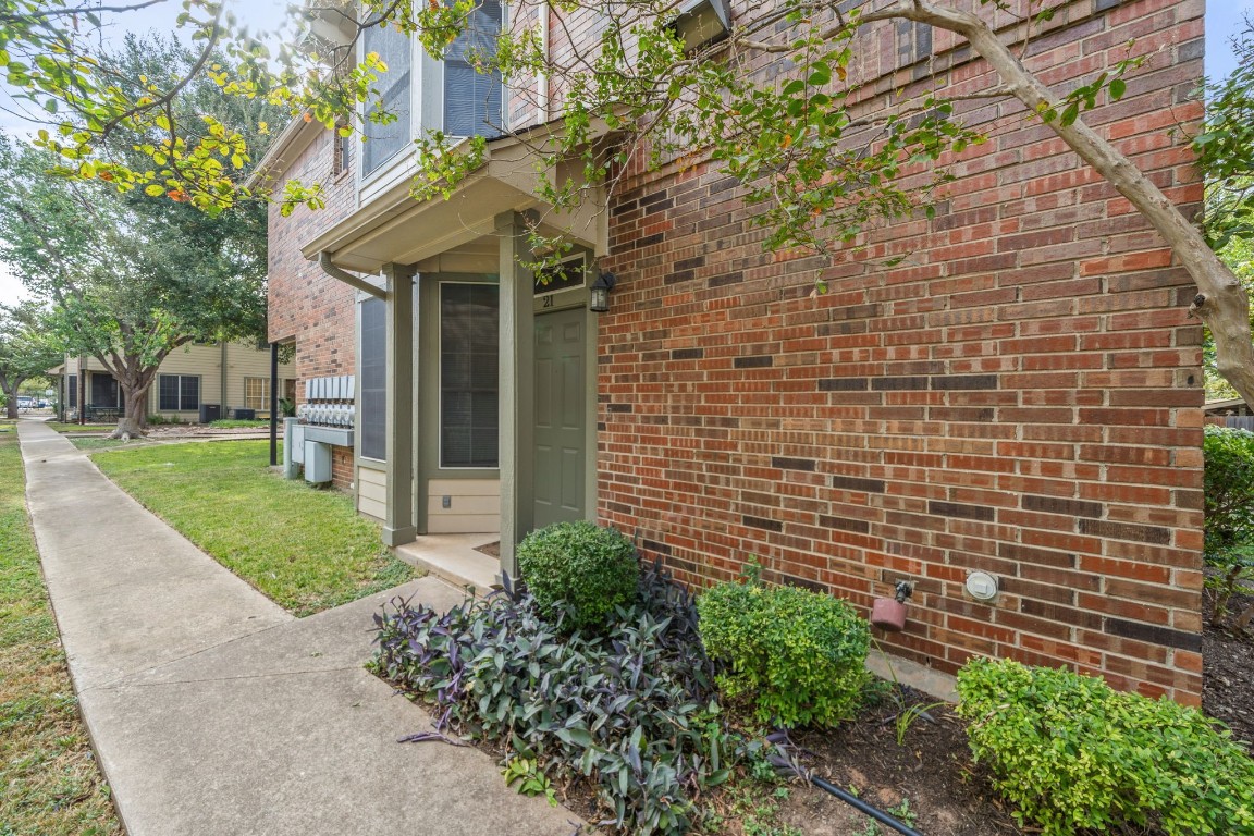 a view of a brick house with a yard