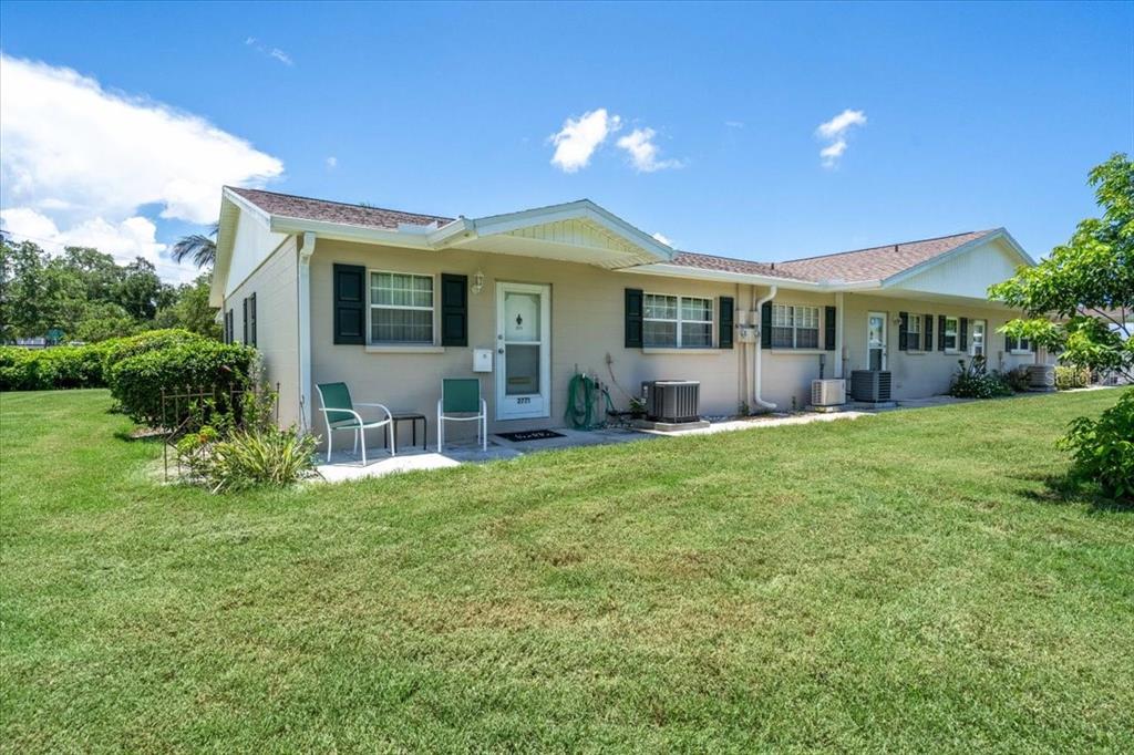 a front view of house with yard and green space