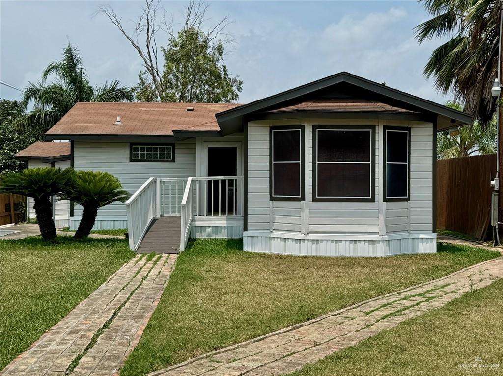 a view of a house with a yard