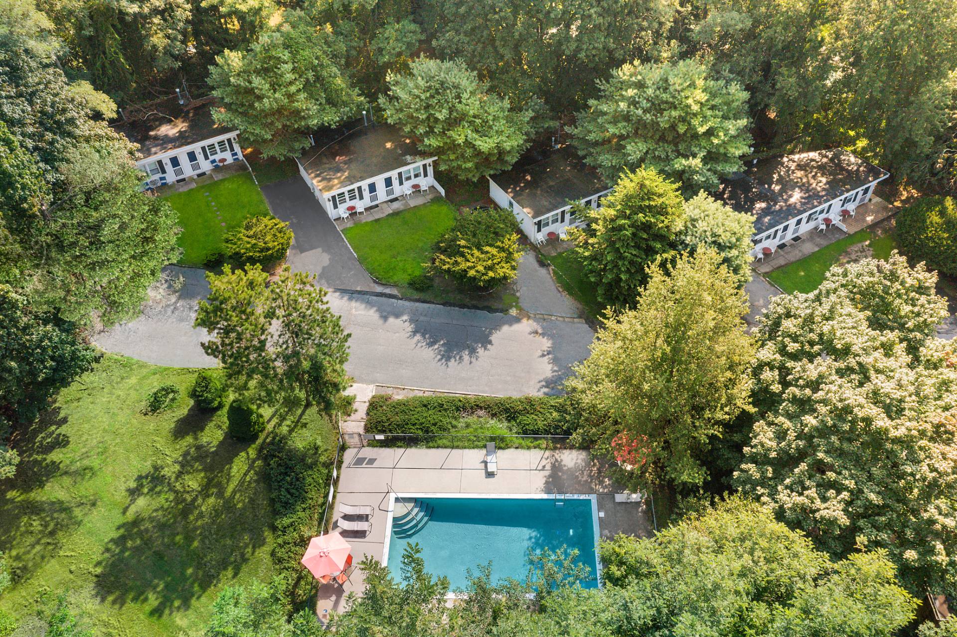 an aerial view of a house with a yard and lake view