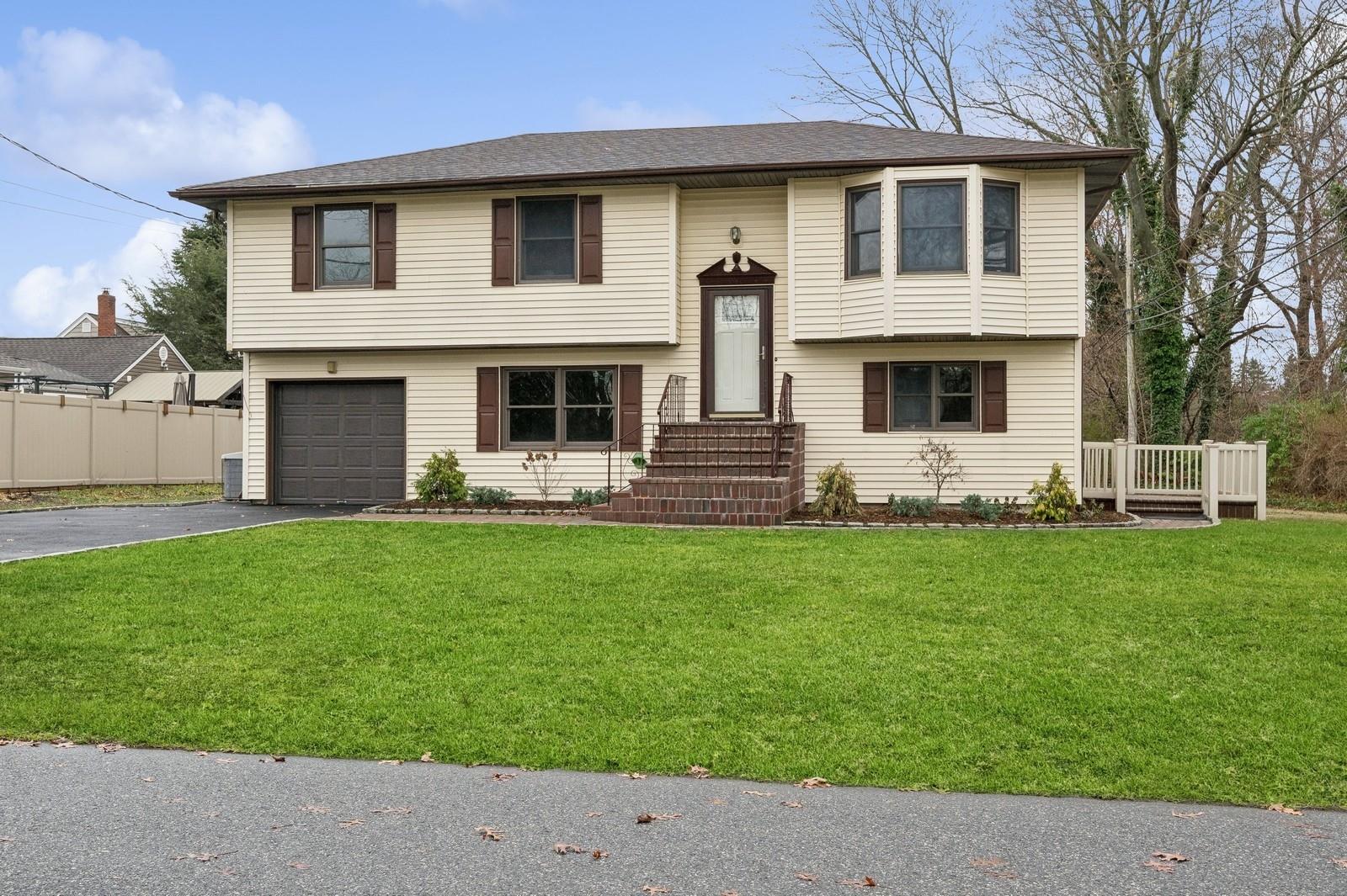 a front view of a house with a garden