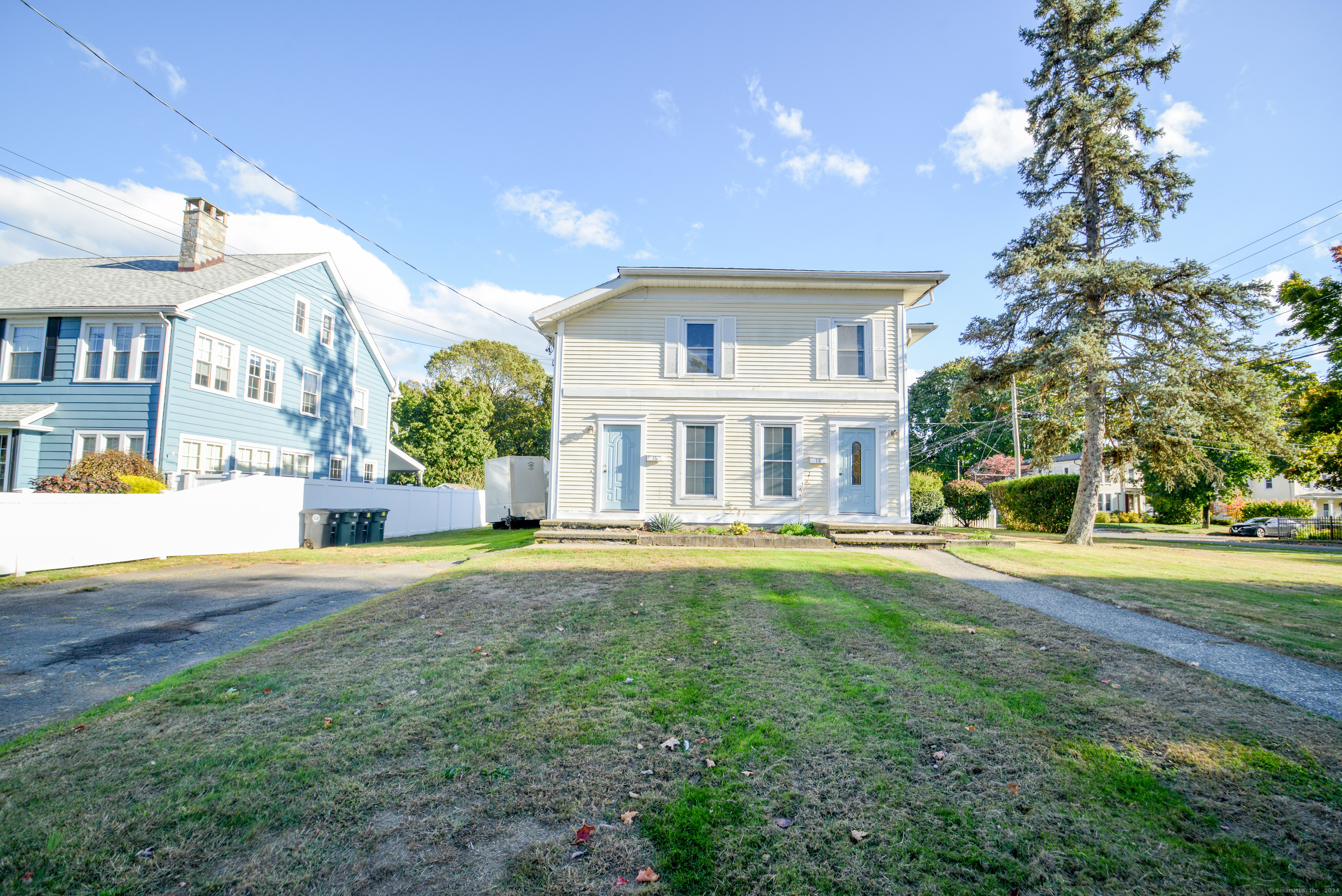 a front view of house with yard and green space