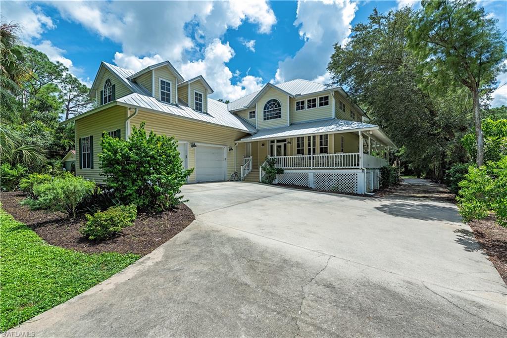 View of front of home with covered porch and a garage