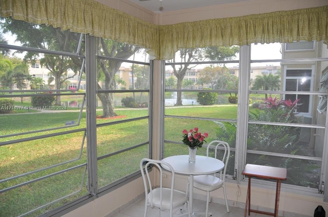 a view of a dining room with furniture window and outside view