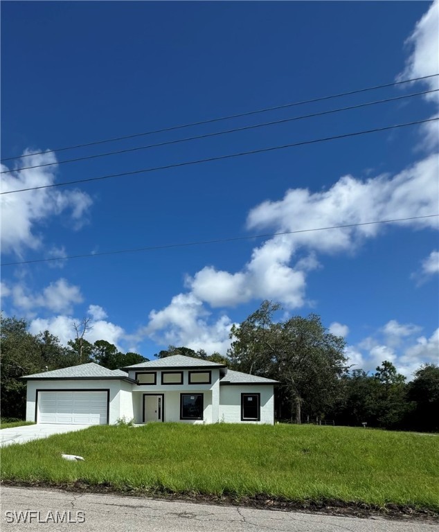 a view of house in front of a big yard with large trees