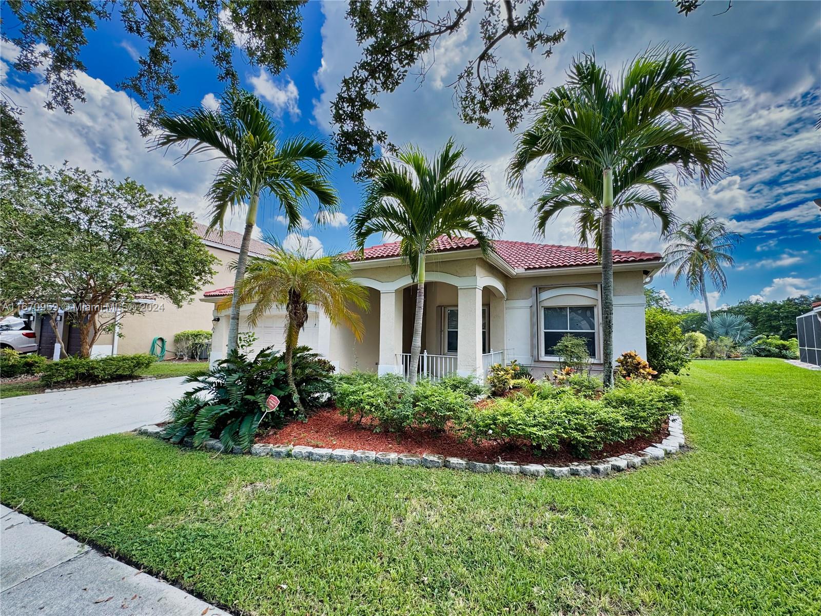 a front view of a house with a garden