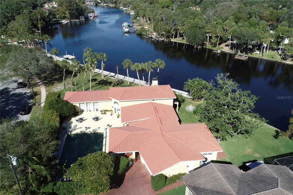 an aerial view of house with yard and lake view