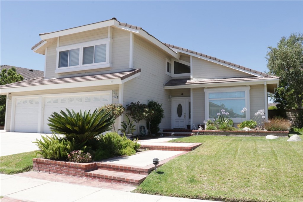 a front view of a house with a yard and outdoor seating