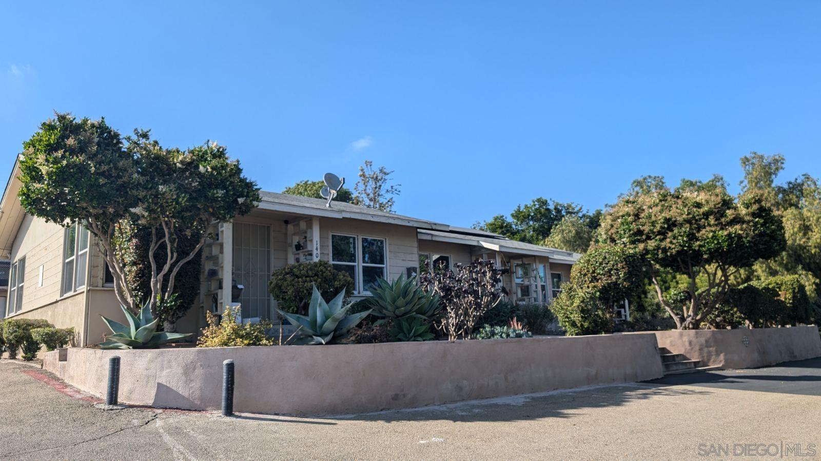 a view of a house with a garden and pathway