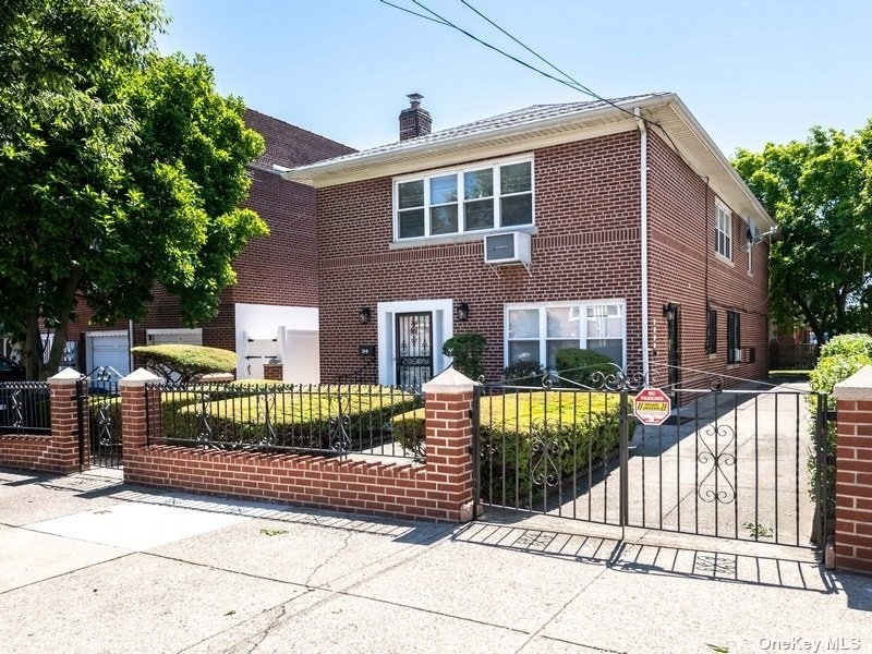 a front view of a house with a fence