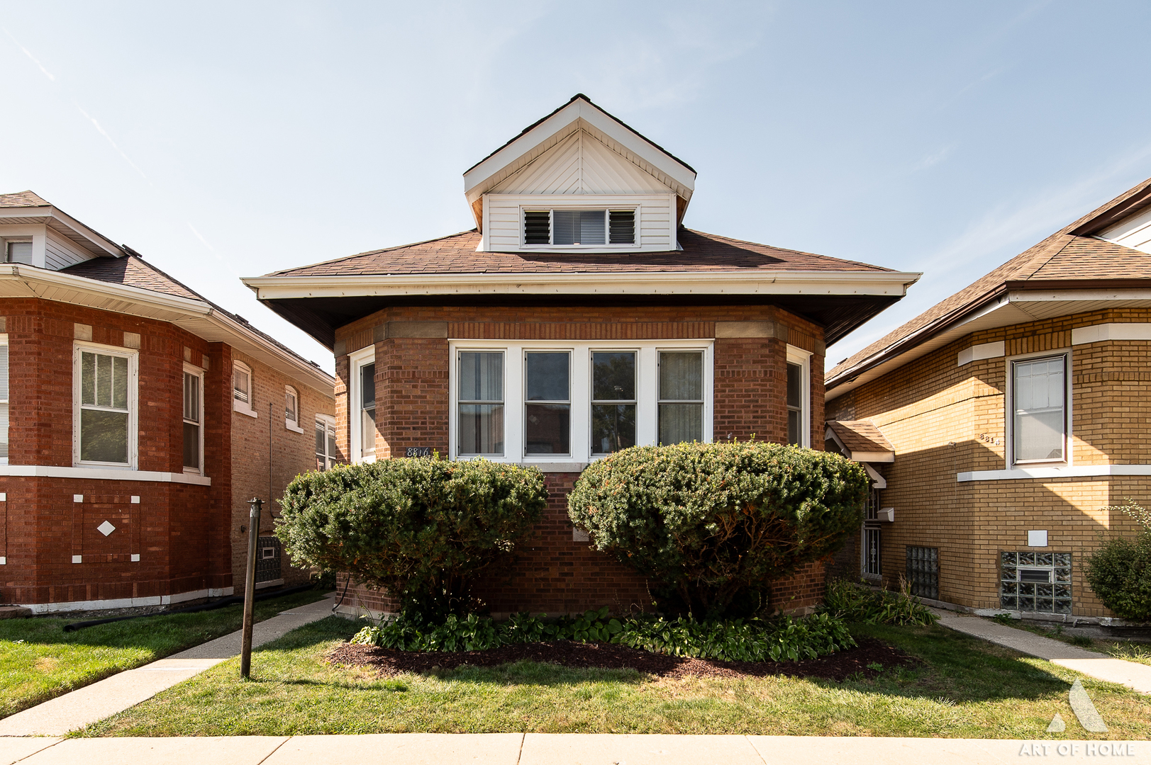 a front view of a house with garden