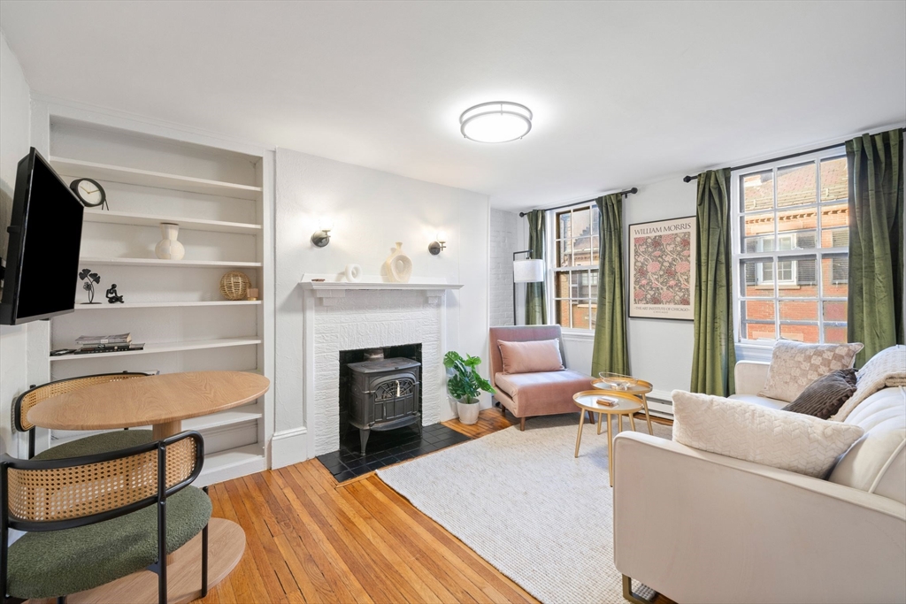 a living room with furniture fireplace and a flat screen tv