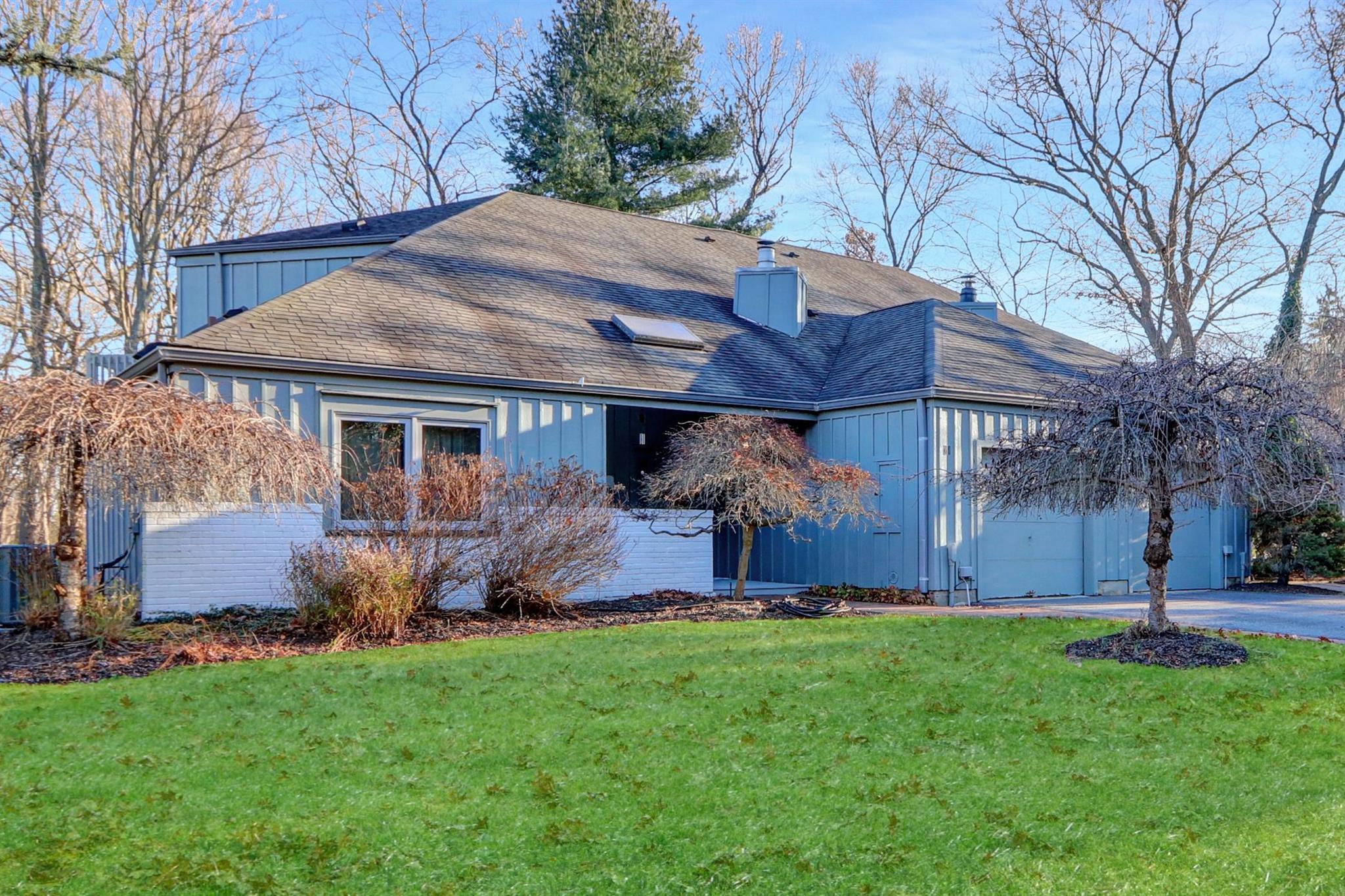 View of home's exterior with a yard and a garage