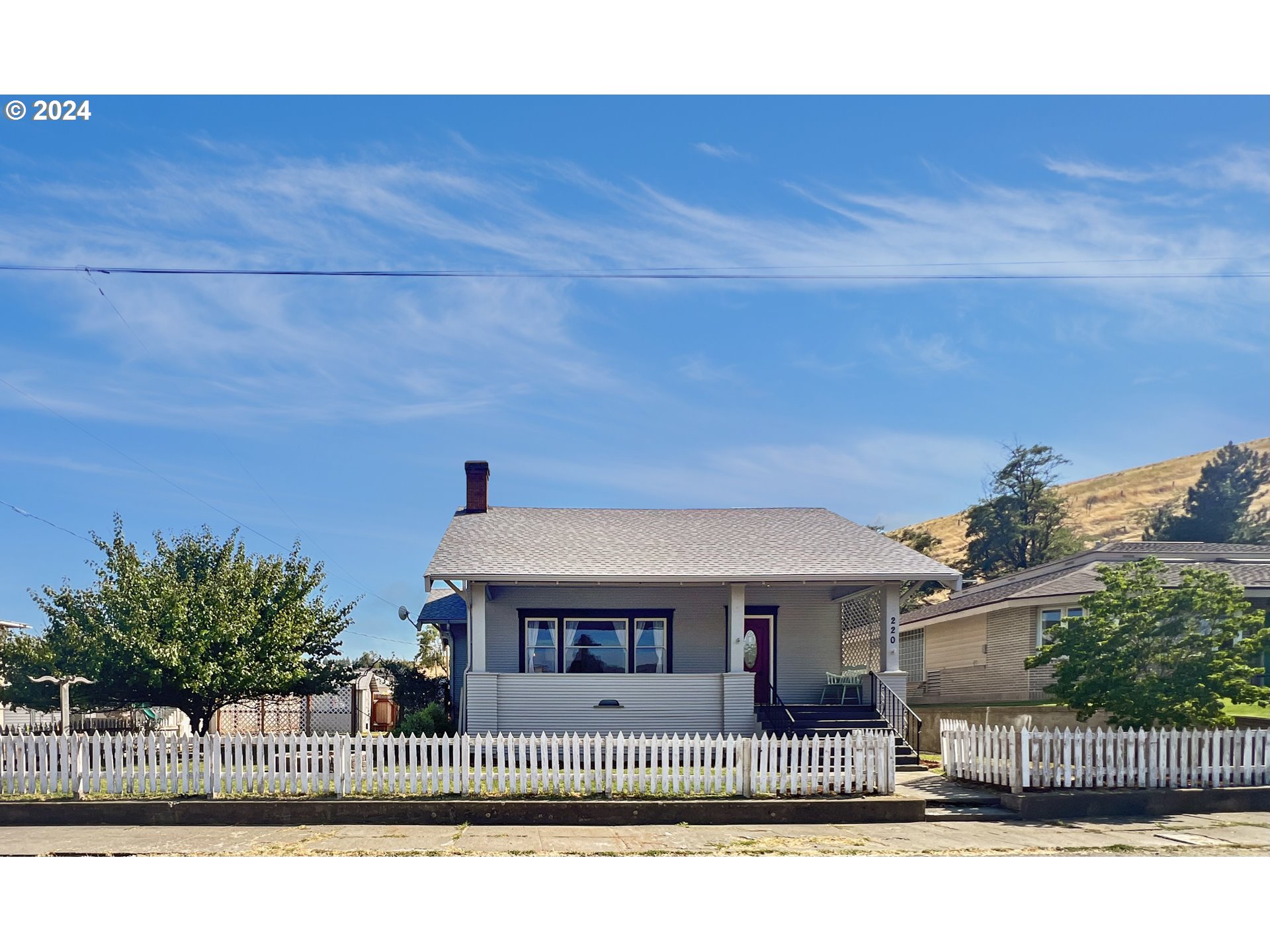 a view of a house with wooden fence