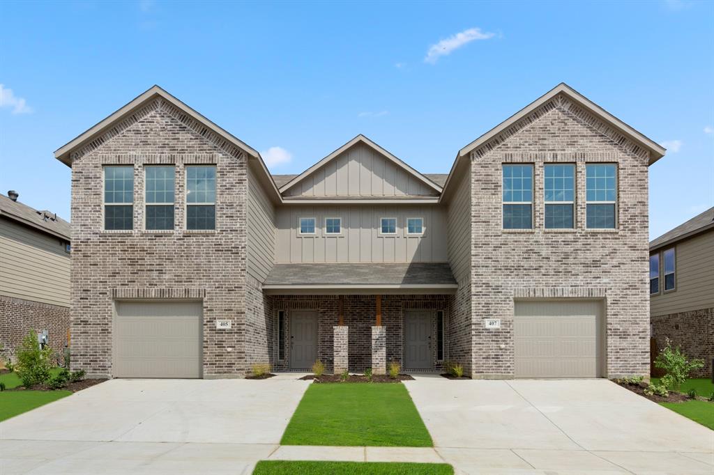 a front view of a house with yard and garage