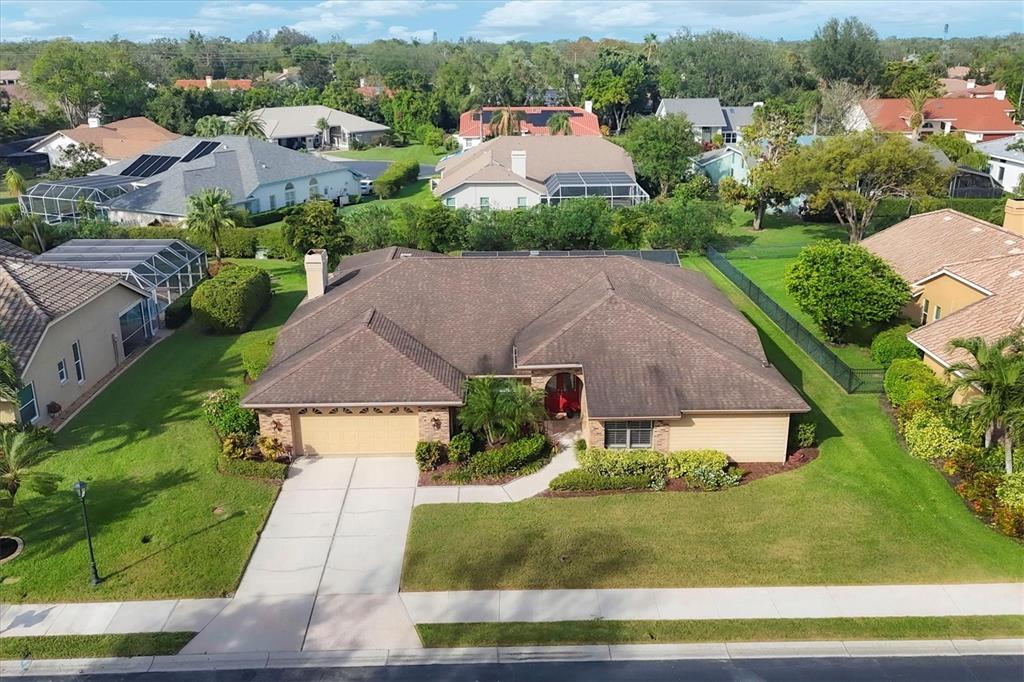 an aerial view of a house with a yard