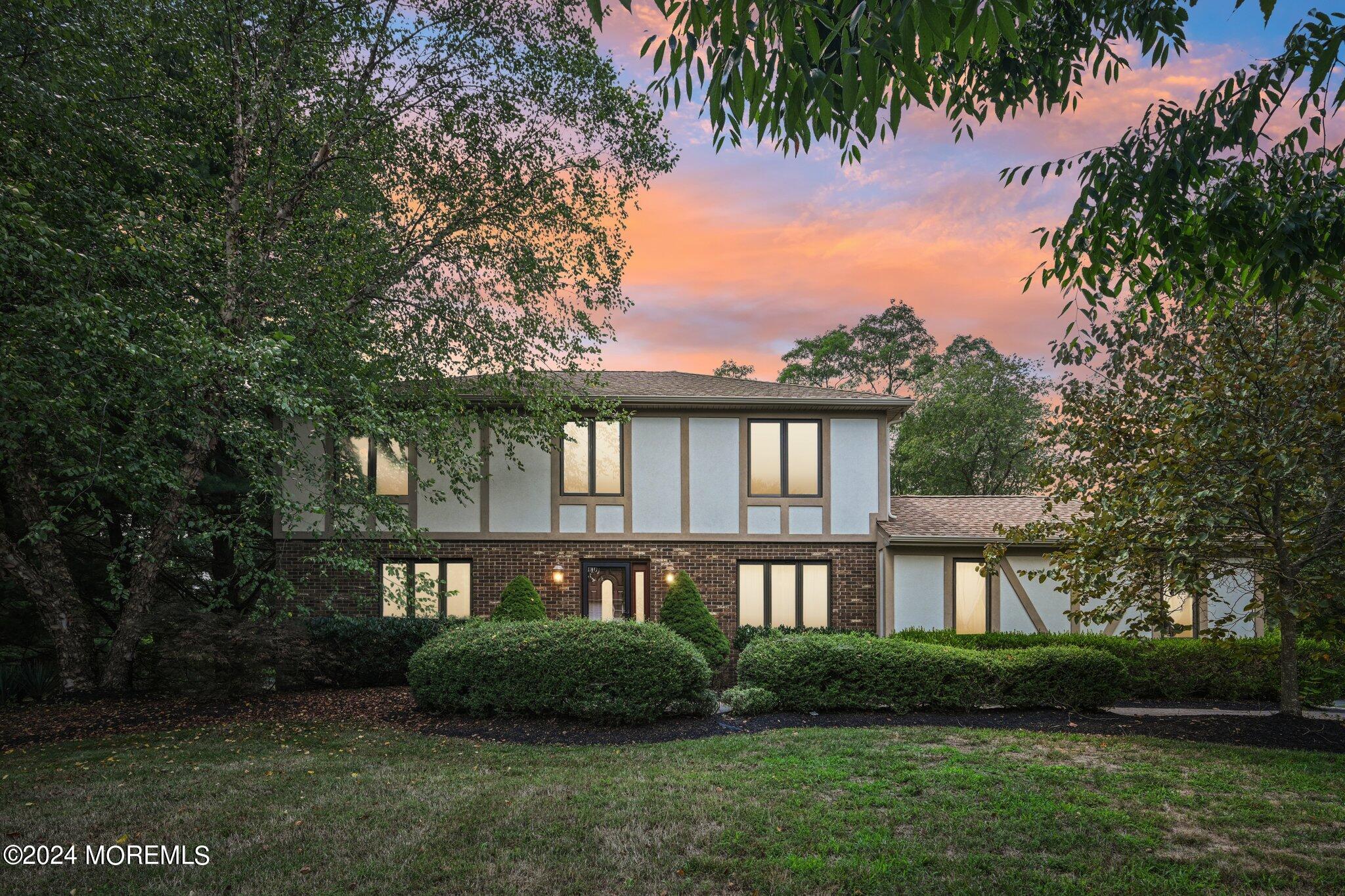 a front view of a house with garden