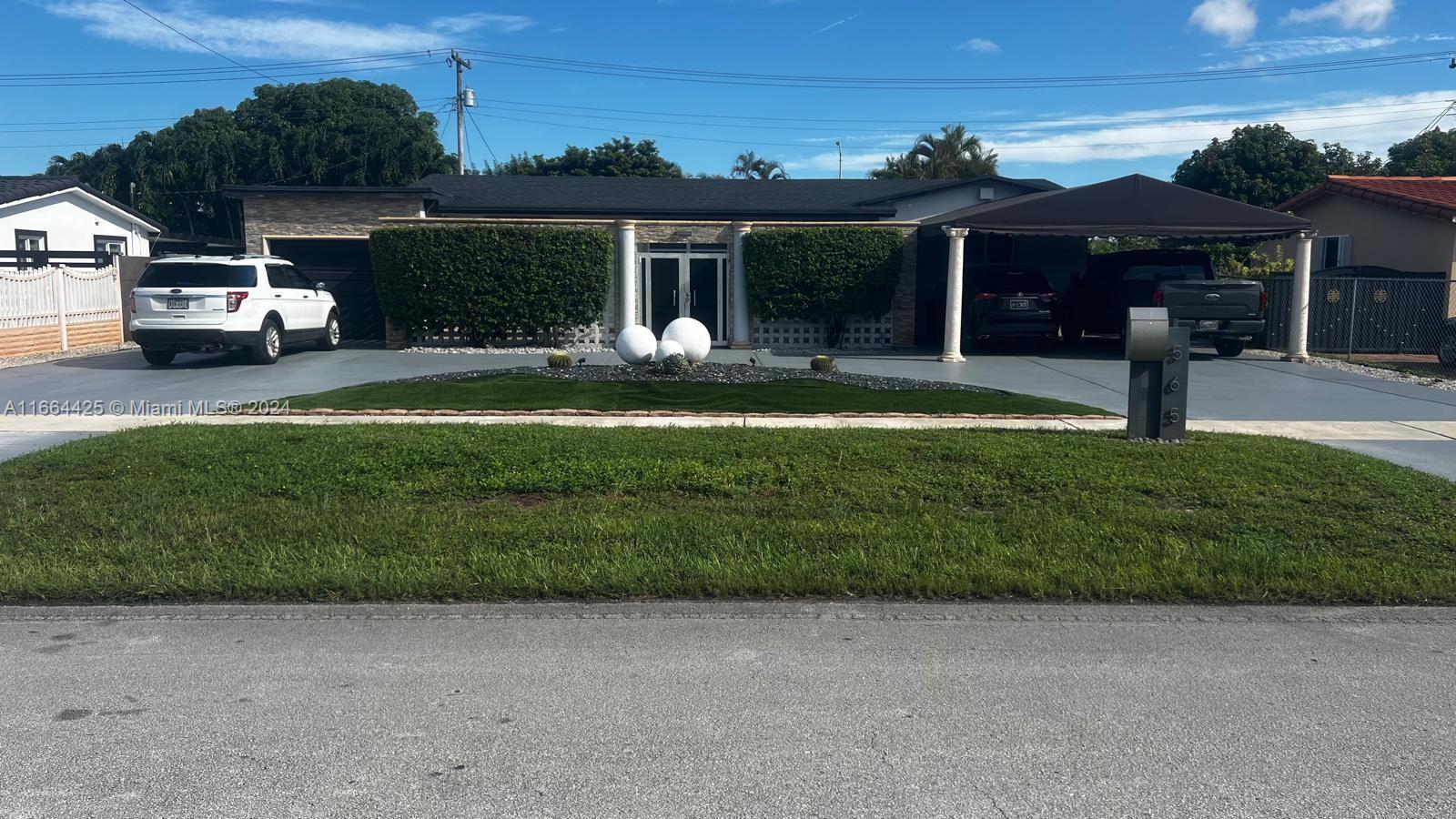 a front view of a house with a garden