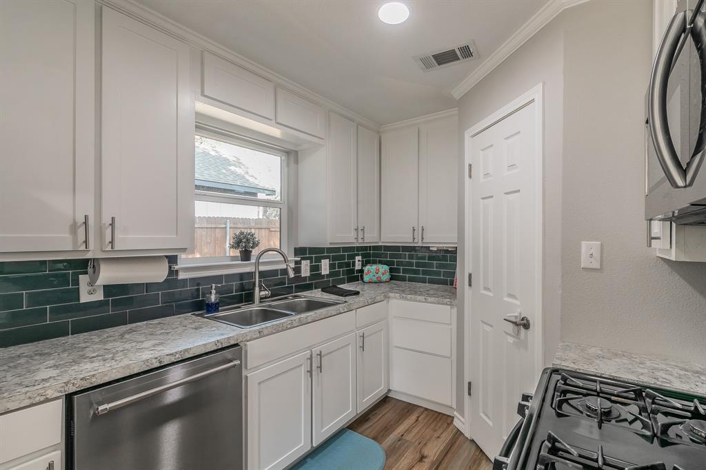 a kitchen with a sink stove and cabinets