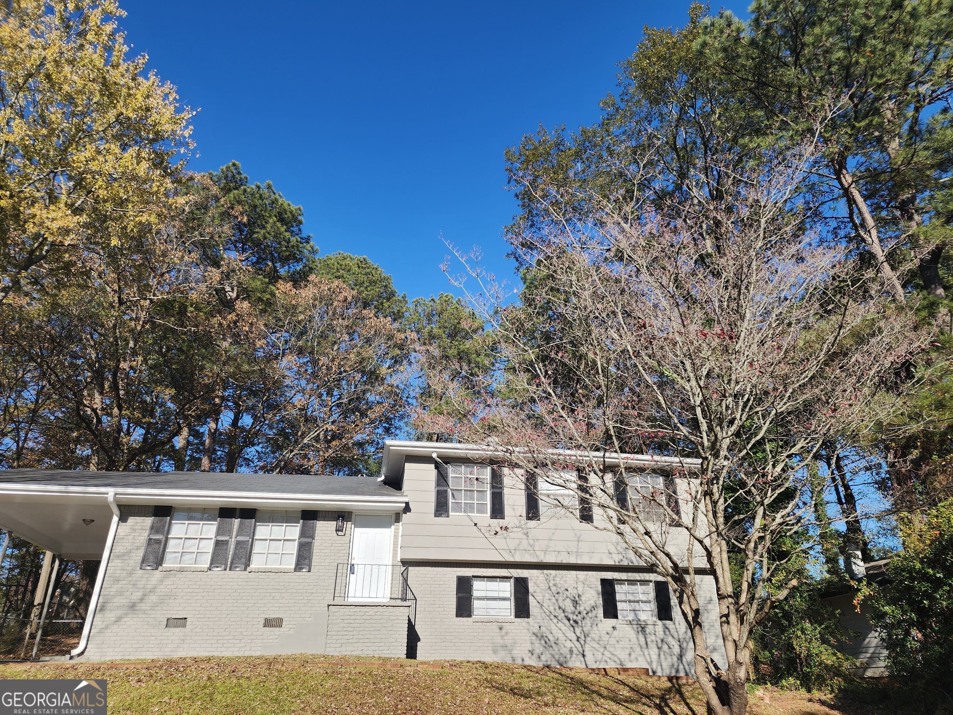 a front view of a house with a garden