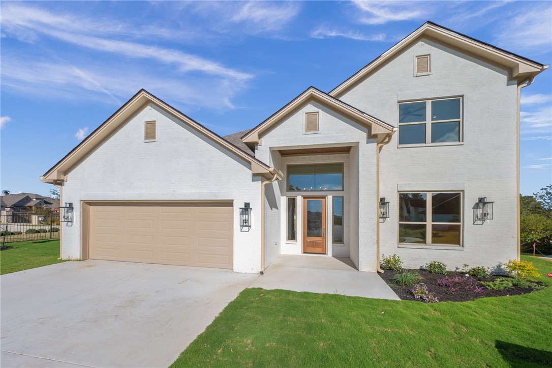 View of front of house featuring a garage and a fr