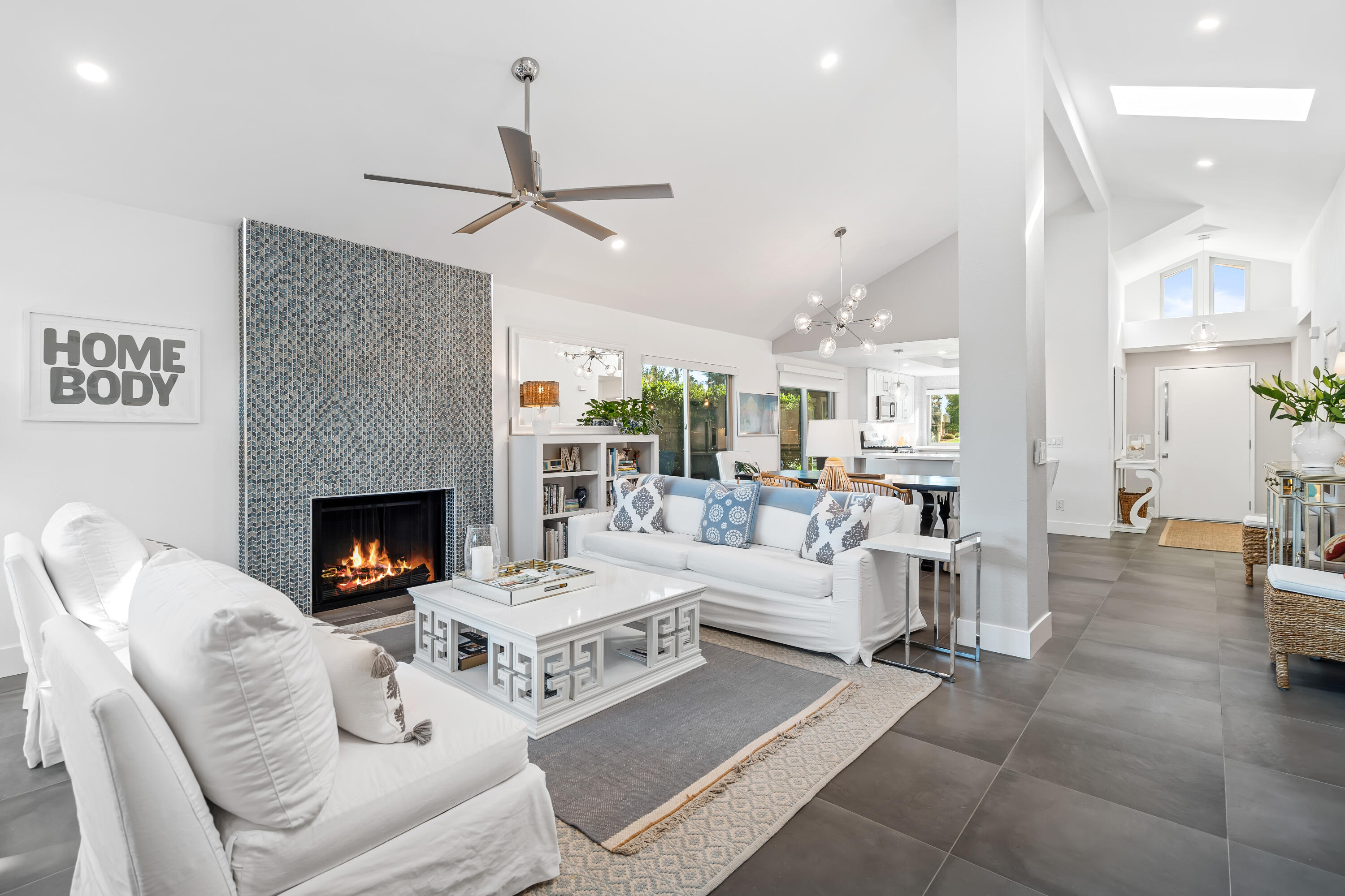 a living room with furniture a fireplace and a table