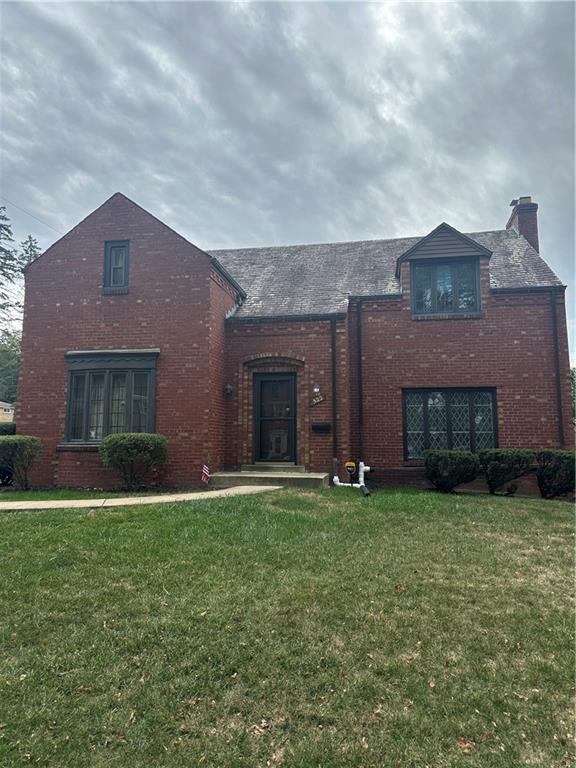 a brick house with a yard in front of it