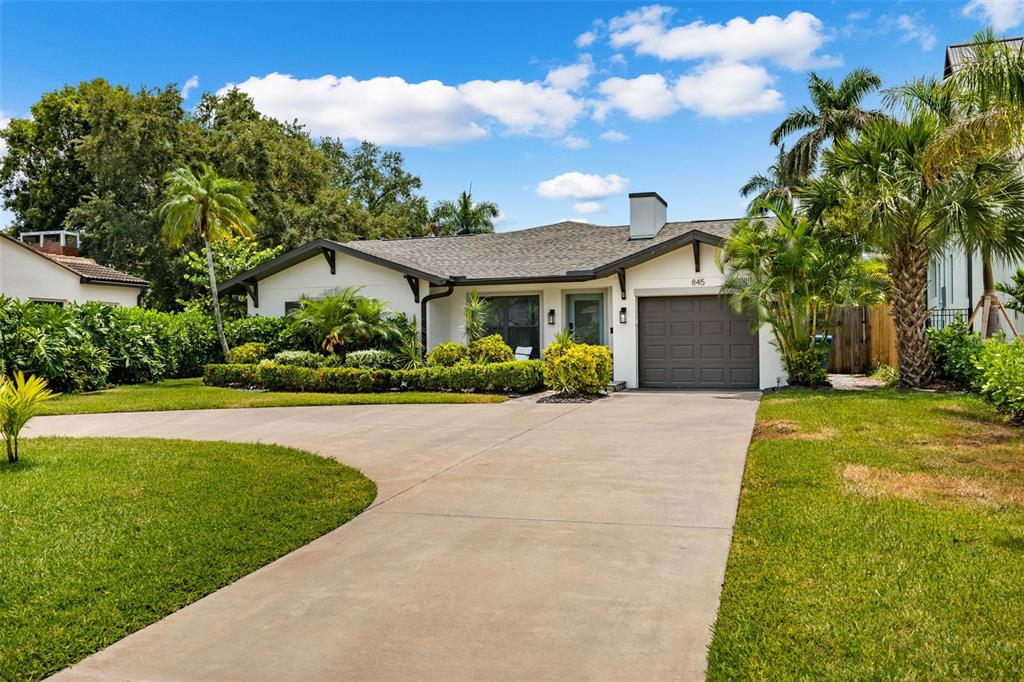 a front view of a house with a garden