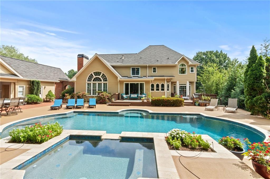 a front view of a house with swimming pool having outdoor seating