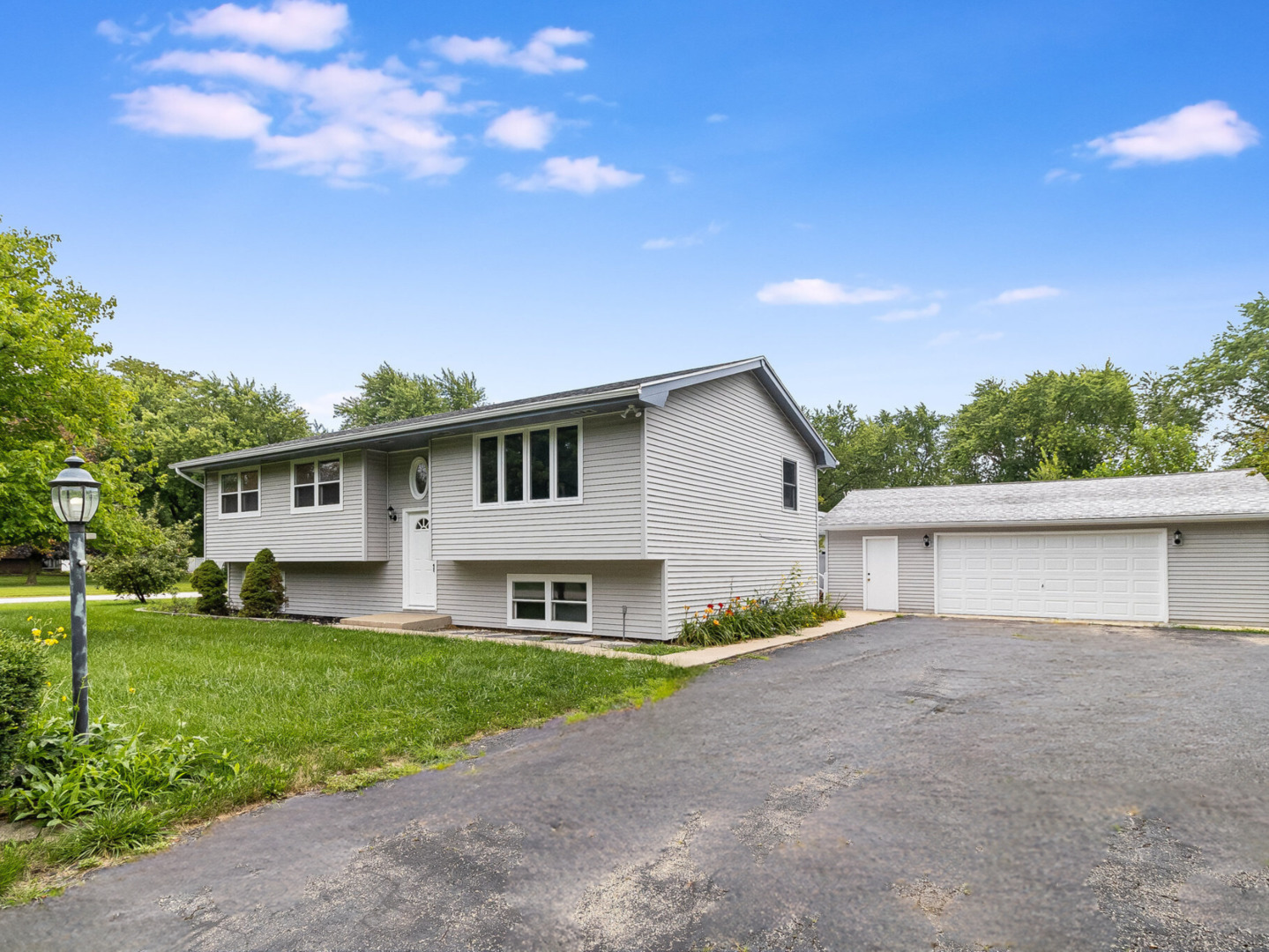 a front view of house with yard and green space