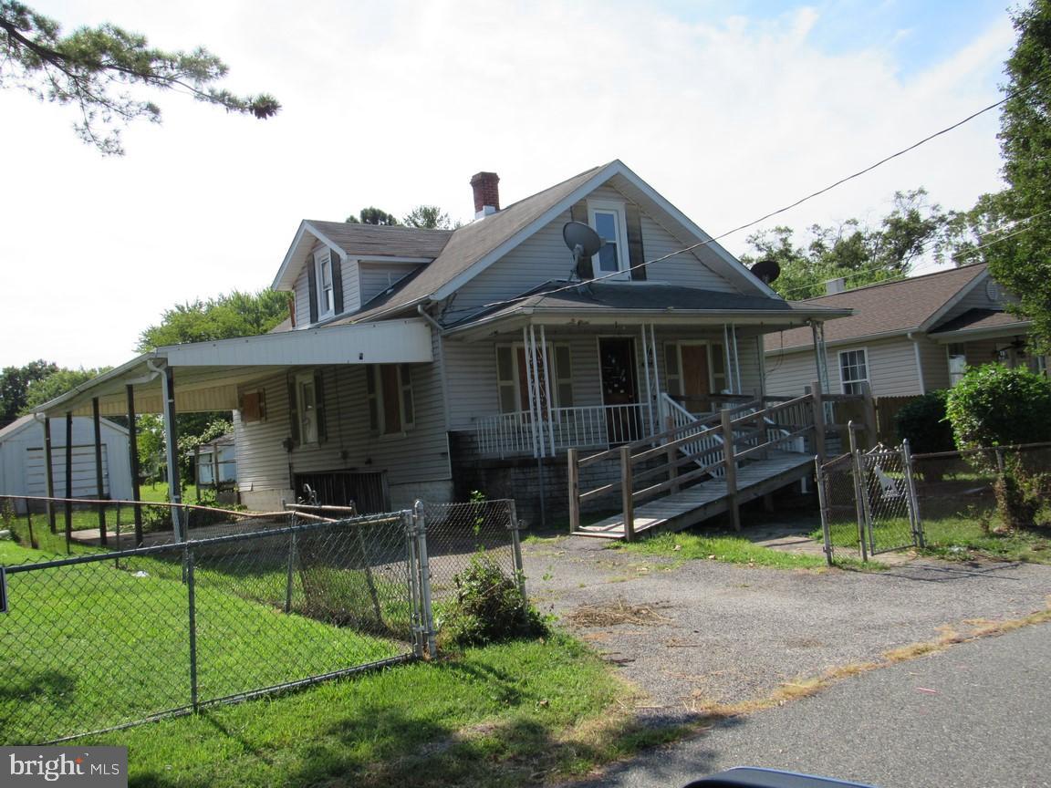 a front view of a house with a yard table and chairs