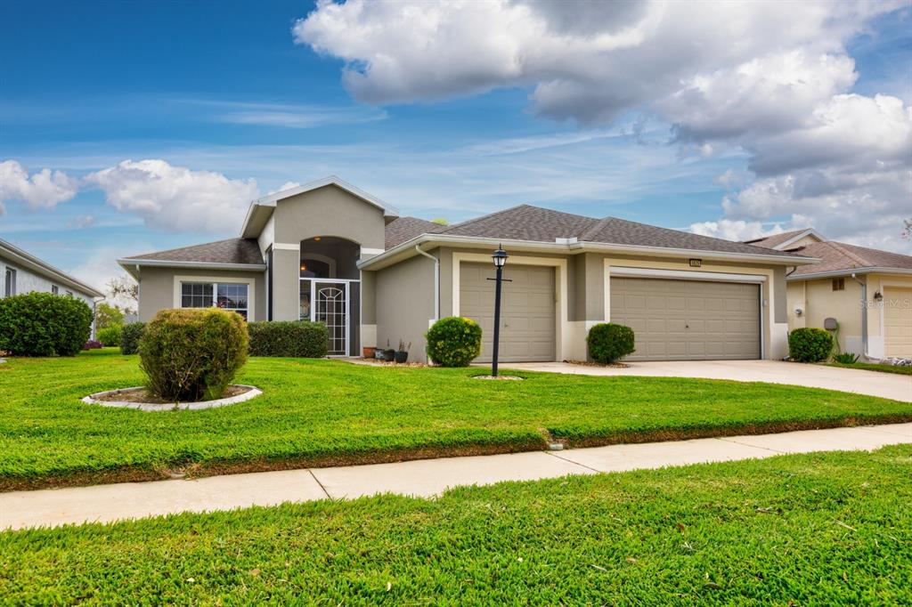 a front view of a house with a yard and garage