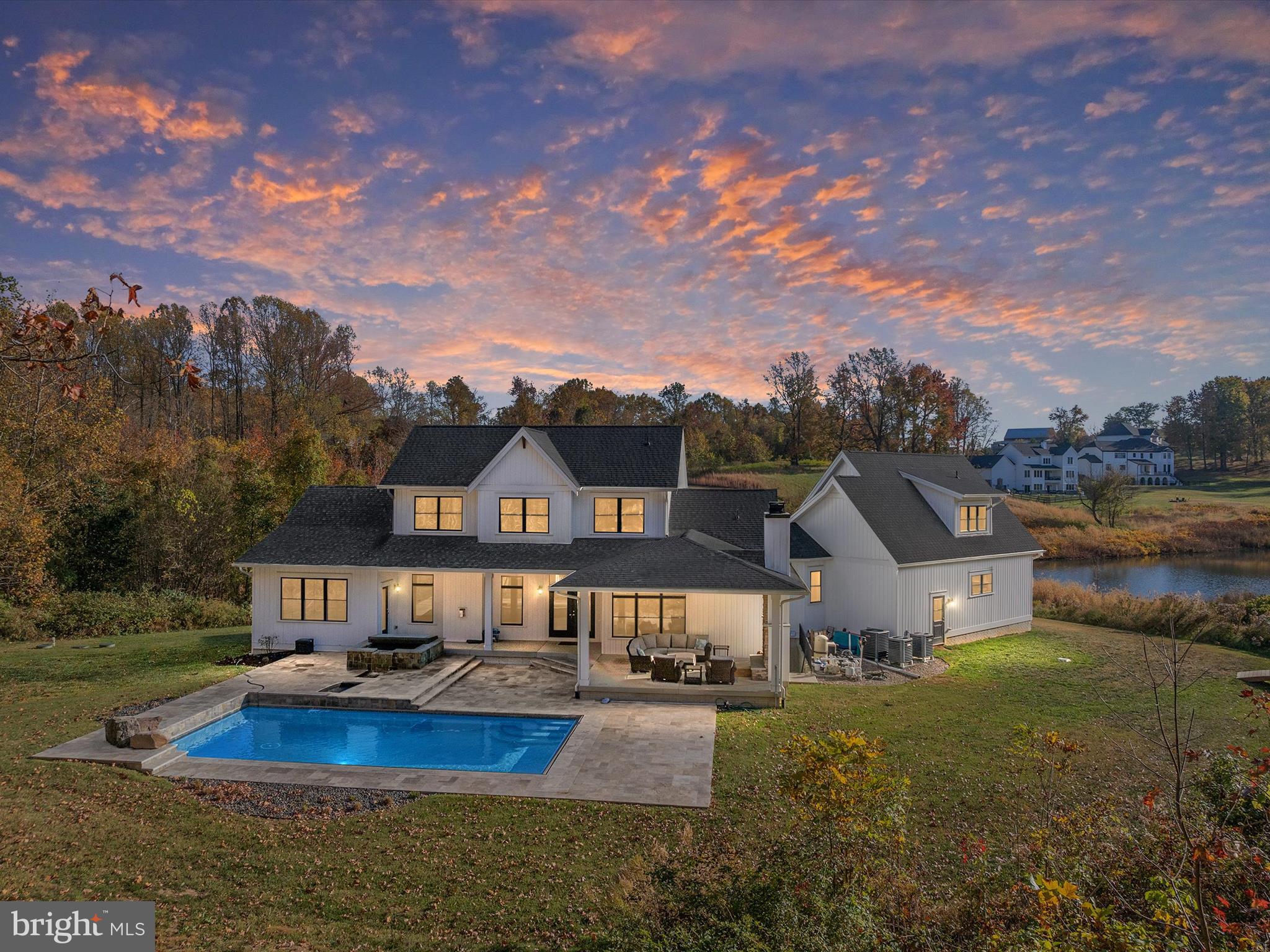 a aerial view of a house with swimming pool and a yard