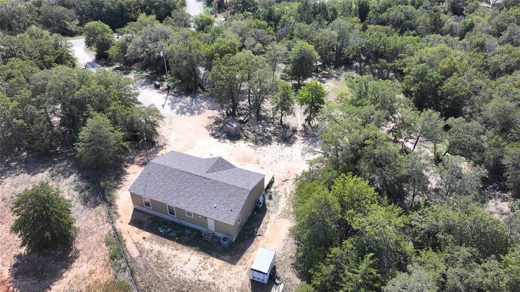 an aerial view of a house with a yard