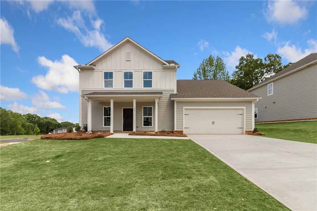 a front view of a house with a yard and garage