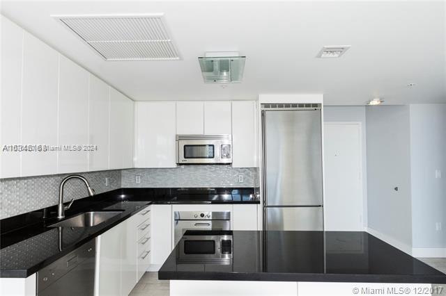 a kitchen with a refrigerator and a sink