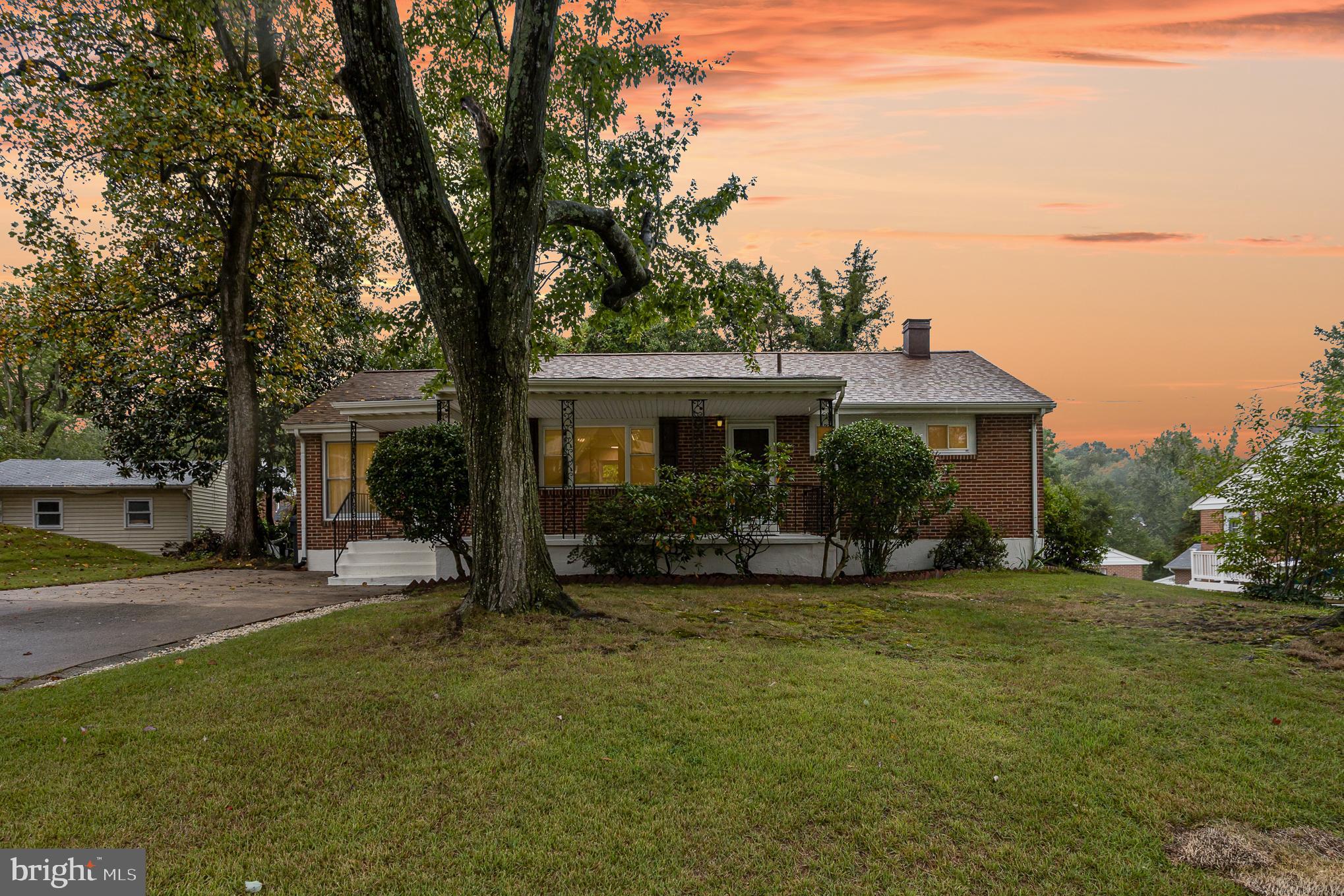 a front view of a house with a garden and patio