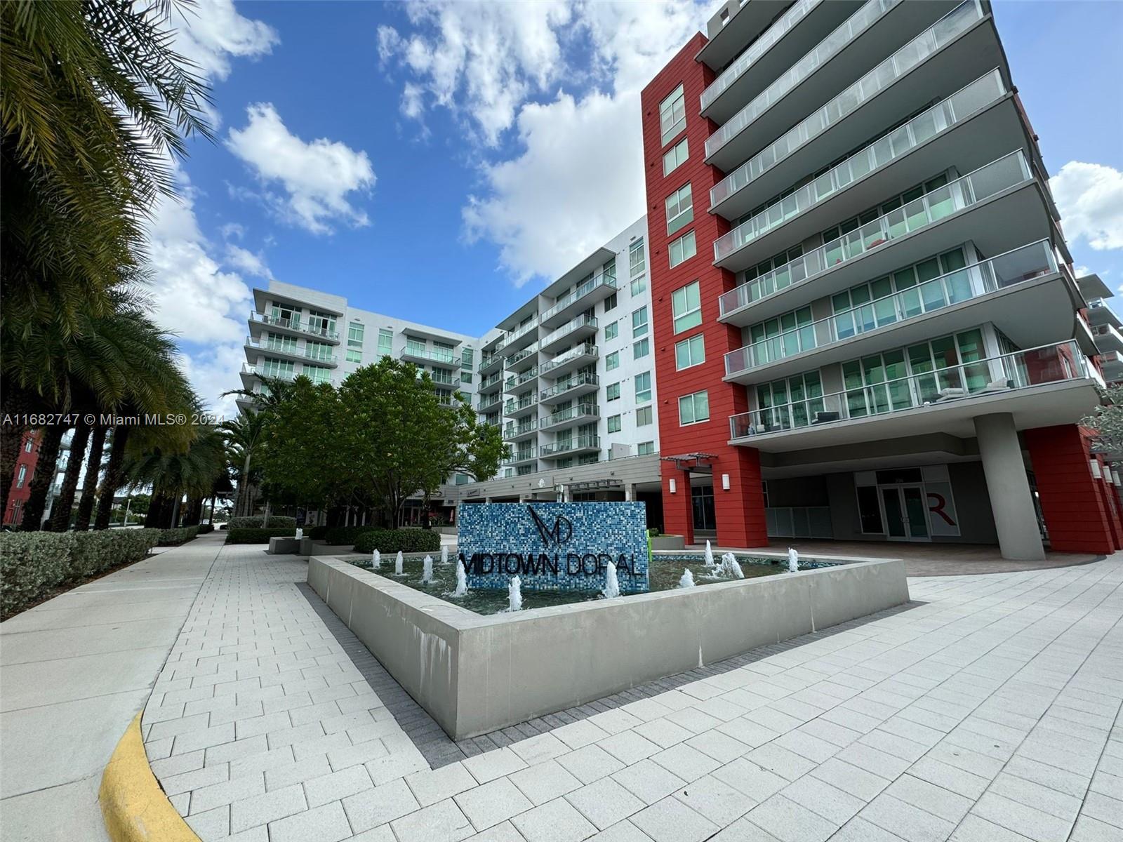 a view of a building with cars