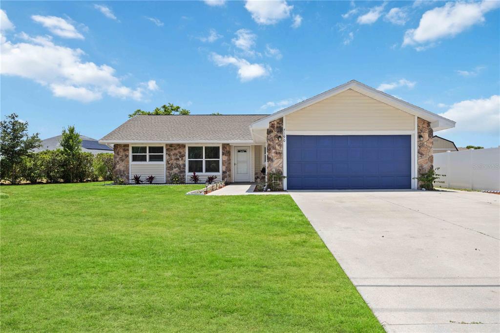 a front view of a house with a yard and garage