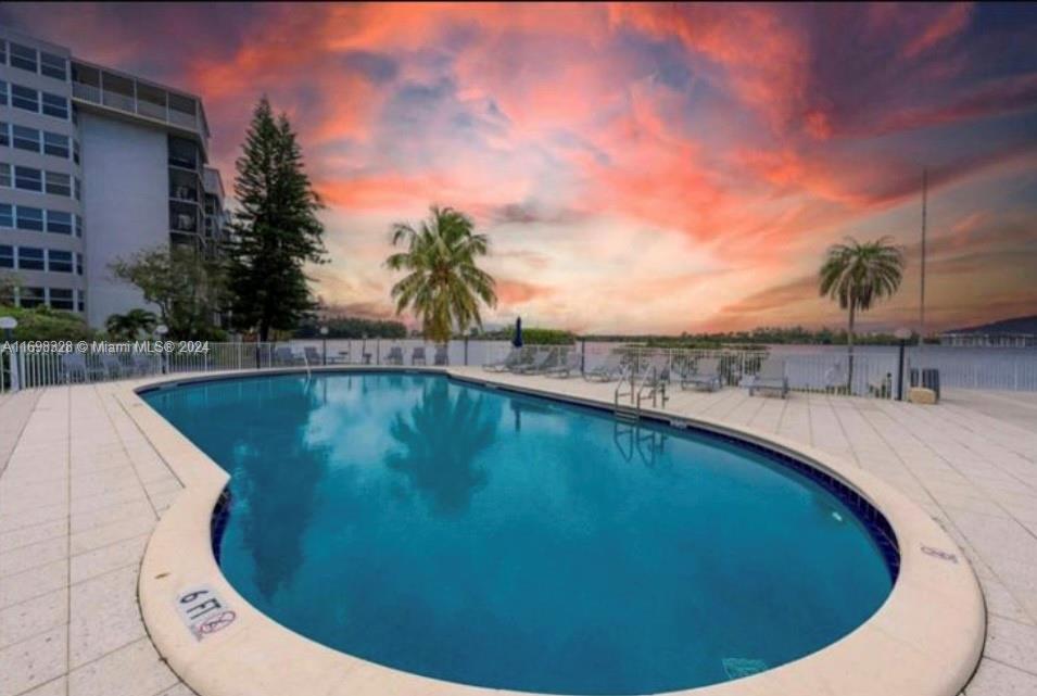 a view of a swimming pool with an outdoor seating