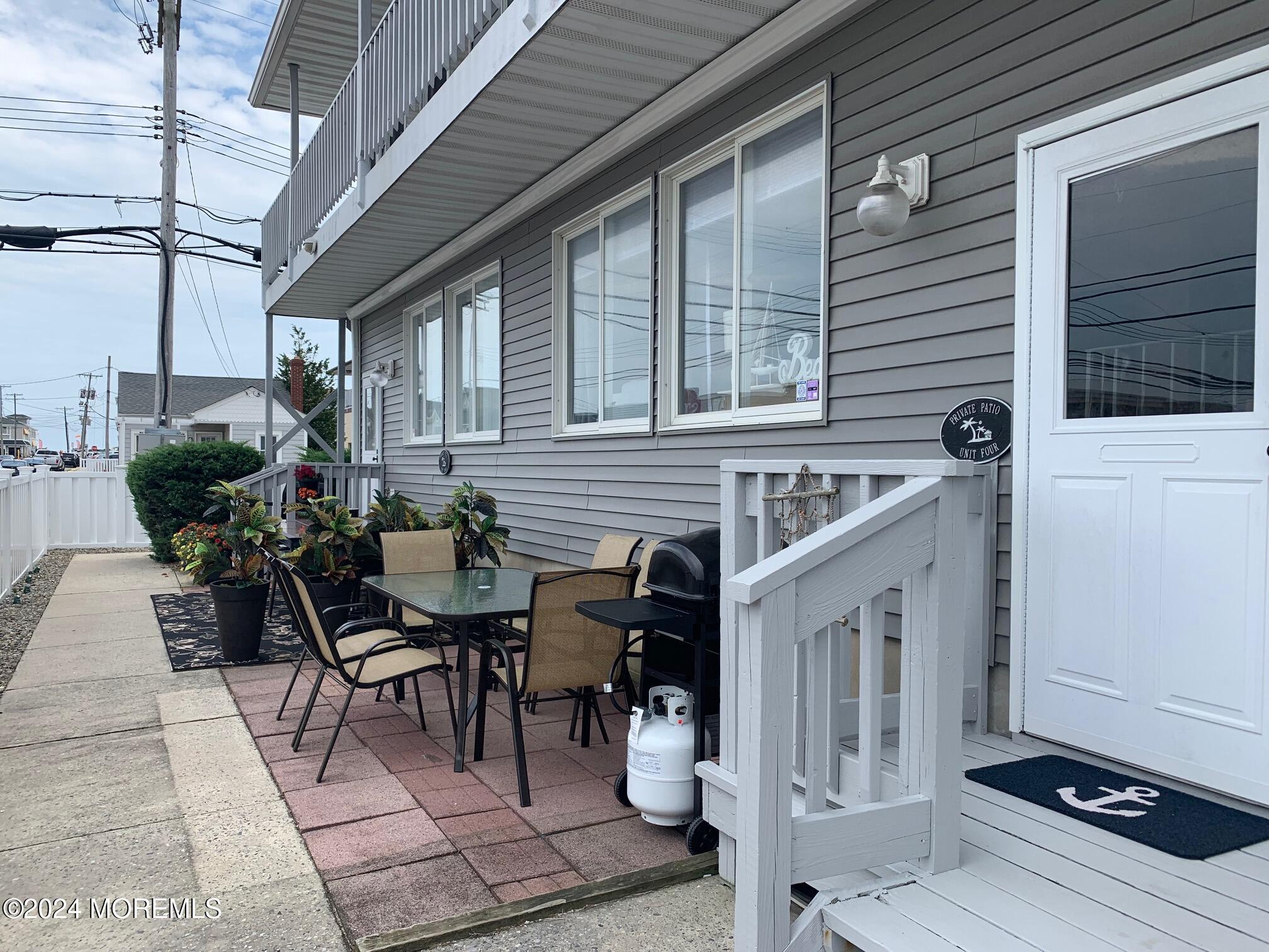 a view of a patio with table and chairs and potted plants