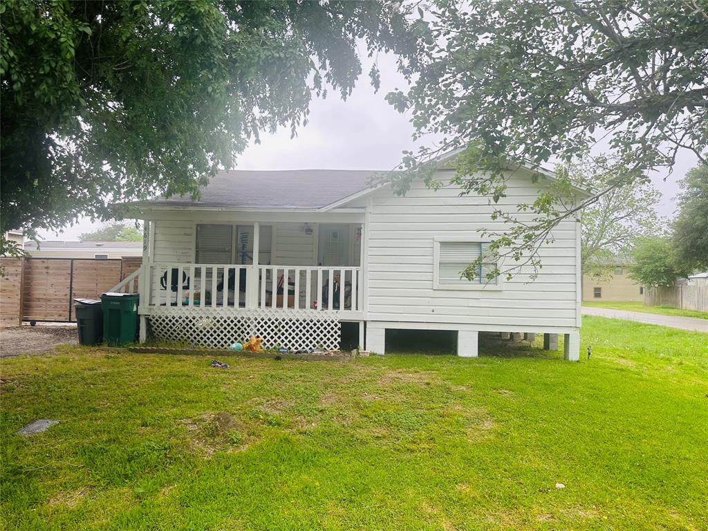 a front view of a house with a garden and deck